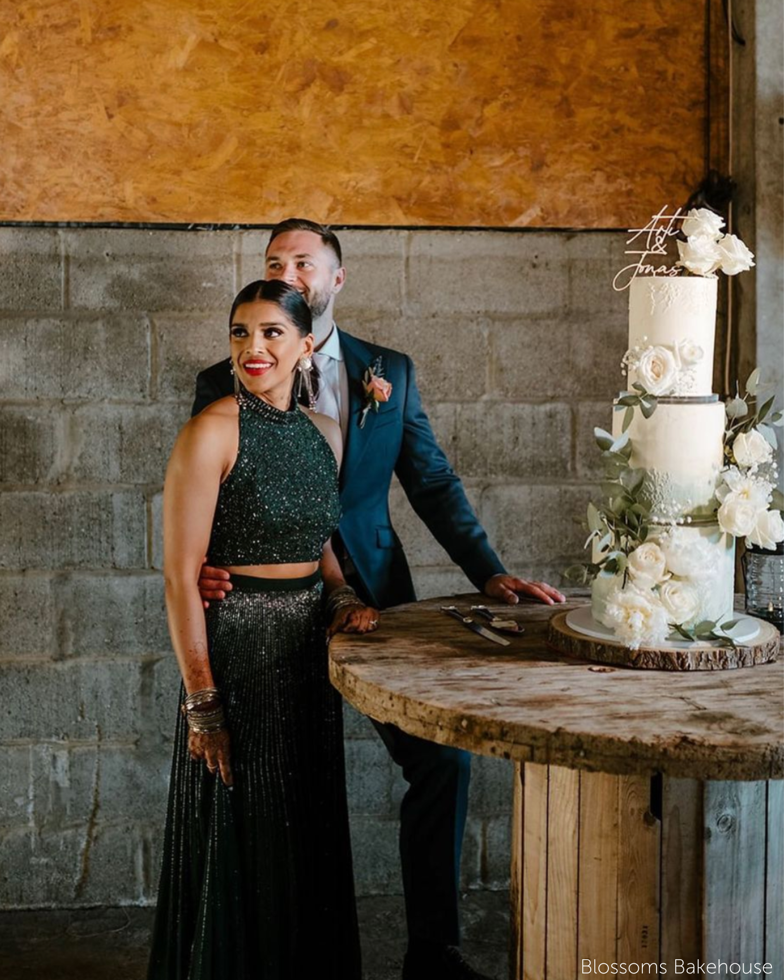 A three tier wedding cake covered in white roses, each tier is separated using a 15mm Acrylic Cake Separator - Prop Options