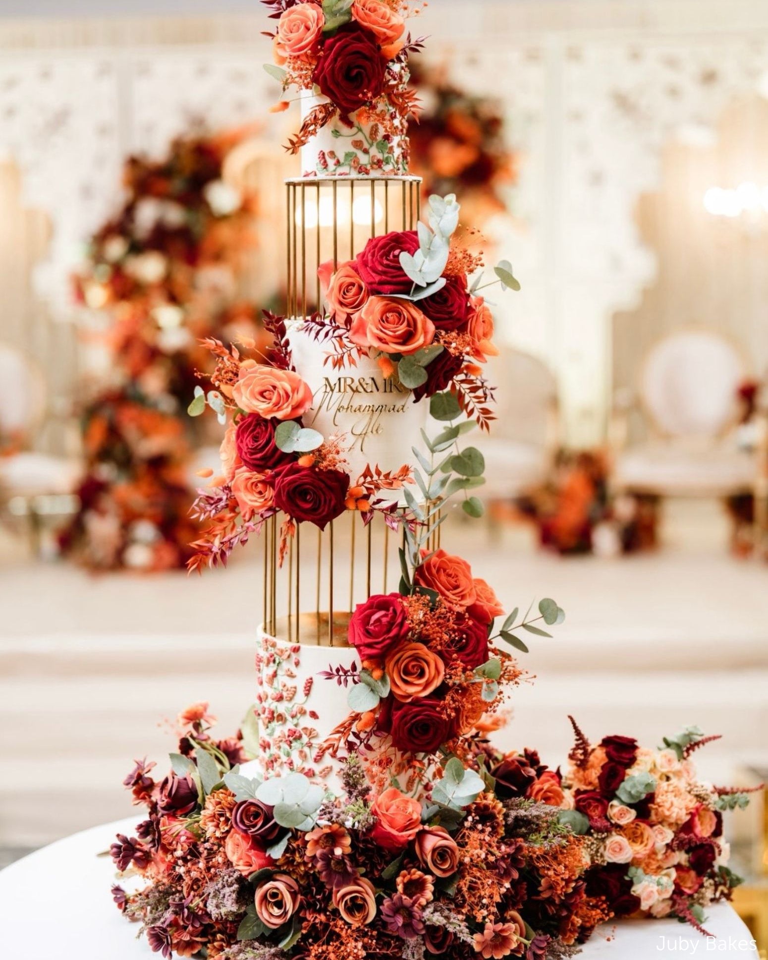 Gold birdcage metal cake separators used in a tall floral wedding cake display by Prop Options