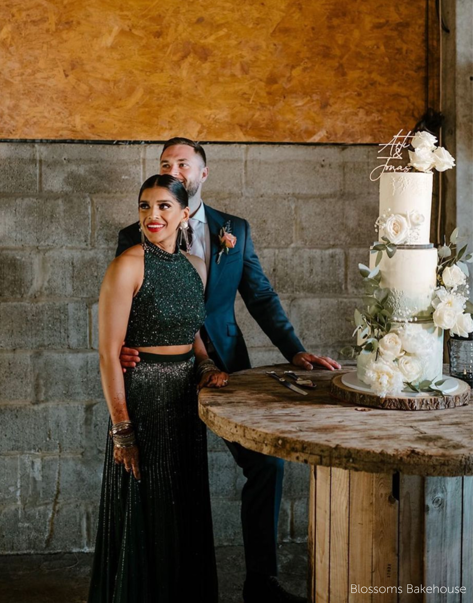 A three tier wedding cake covered in white roses, each tier is separated using a 15mm Acrylic Cake Separator - Prop Options