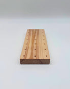 Wooden block with holes on a white background