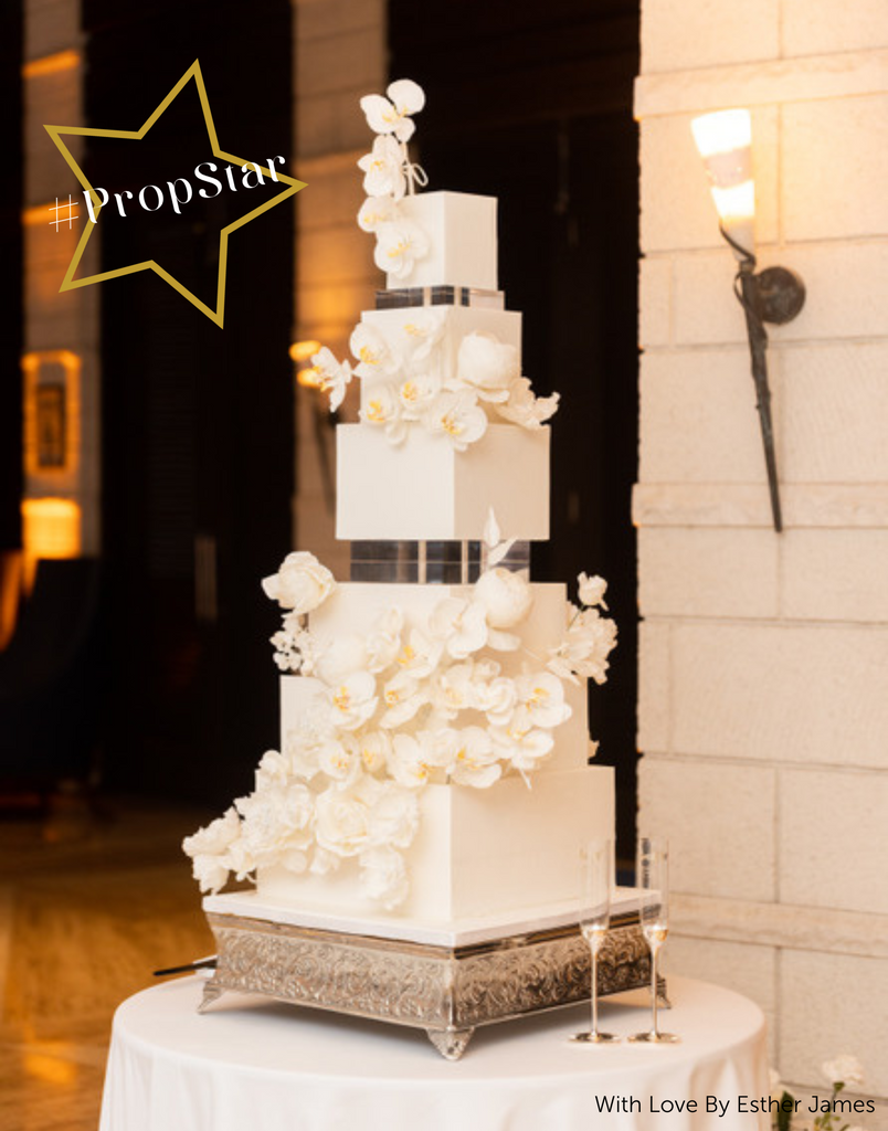 PropStar winning submission - a square white multilayered cake with white florals, each layer is separated by a 30mm Square Acrylic Cake Separator - Prop Options