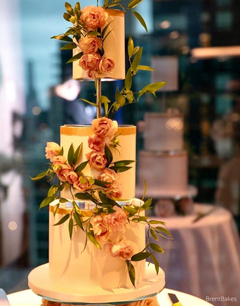 Three tiered cream coloured cake with  pink flowers, the top two tiers are separate using a PropSecure® Adjustable Central Bar Cake Separator - Prop Options