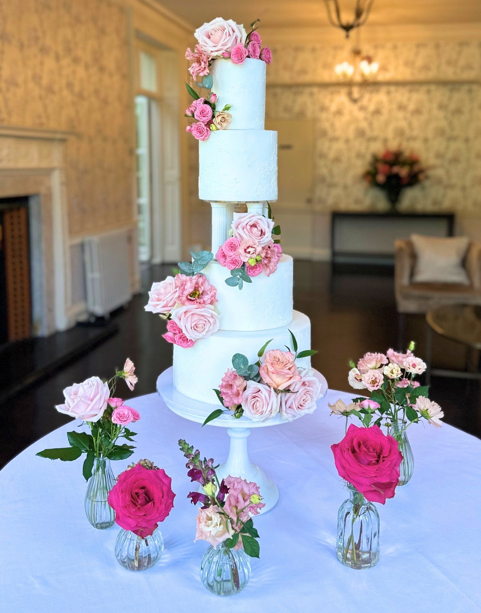 Elegant tiered wedding cake supported by a Prop Options column cake separator