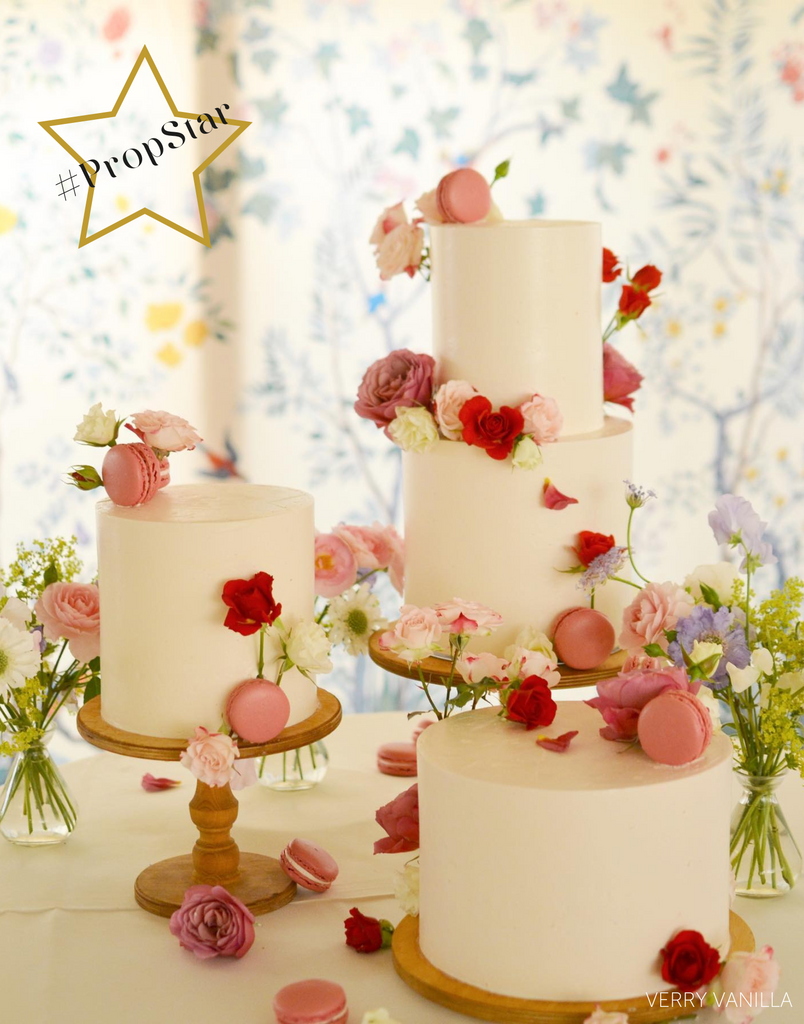 PropStar winning submission - three white cakes covered in pink macarons and red and white flowers stood on a trio of Original Scandinavian Birch Cake Stands - Prop Options