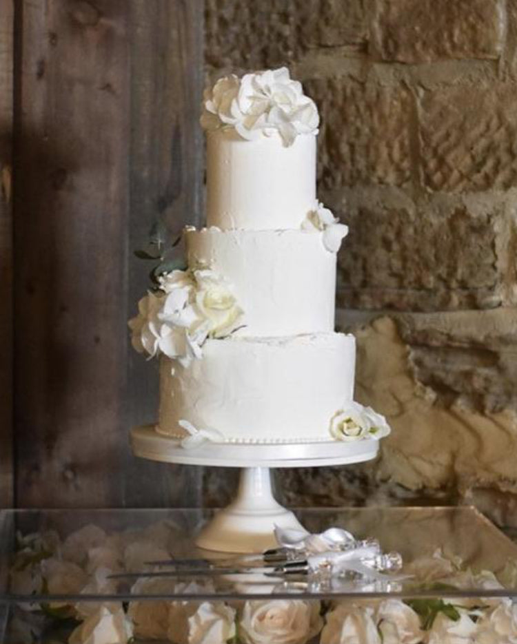 Prop Options Carbon steel adjustable cake stand displaying stunning white 3 tier wedding cake