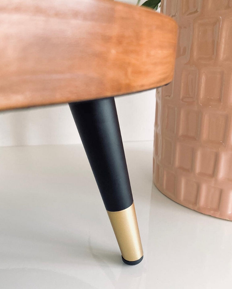 Prop Options Solid wood stand with matte black and gold tapered legs up close