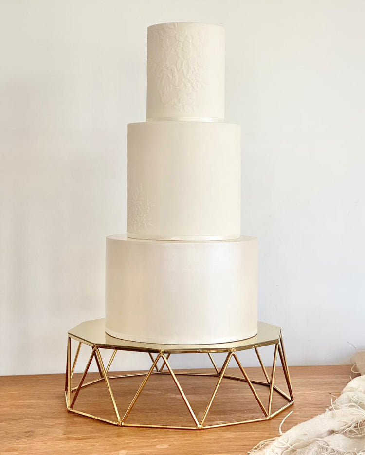 Geometric Cake Stand holding up a plain white three layer cake - Prop Options