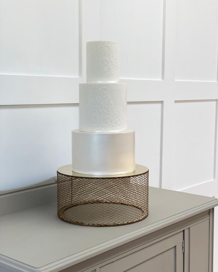 Gold metallic mesh cake stand with three tiered wedding cake 