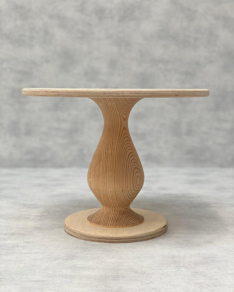 The Teardrop Scandinavian Birch Cake Stand tall size in a natural finish - Prop Options 