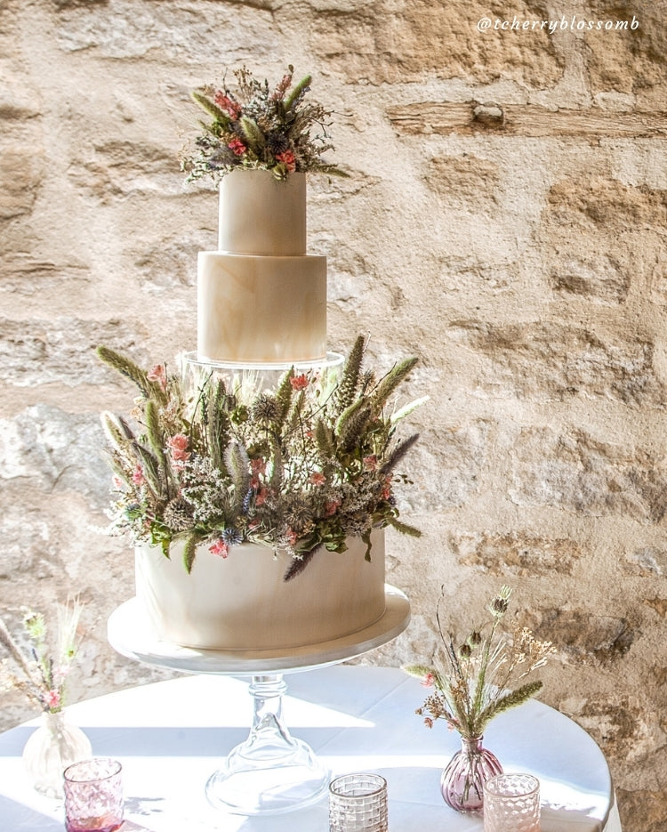 Prop Options clear fillable cake tier - floating cake illusion. Stunning tiered wedding cake using dried floral decorations.
